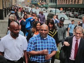 Andre Hatchett, center, walks from court followed by family after his exoneration in court Thursday March 10, 2016, in Brooklyn, N.Y. Hachett, serving 25 years to life in the killing of Neda Mae Carter, is the 19th wrongfully-convicted prisoner freed by the Brooklyn District Attorney Ken Thompson's Conviction Review Unit. (AP Photo/Bebeto Matthews)