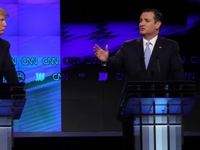 Republican U.S. presidential candidate Donald Trump listens to rival Ted Cruz (R) during the Republican candidates debate sponsored by CNN at the University of Miami in Miami, Florida, March 10, 2016.      REUTERS/Carlo Allegri