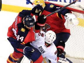 Florida defenceman Erik Gudbranson and Senators winger Bobby Ryan crash into Panthers goalie Roberto Luongo on March 10. (USA Today Sports)