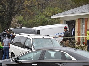 Vicksburg police load the body of escaped murder suspect Rafael McCloud into a coroner's vehicle on Thursday, March 10, 2016, after he was shot by a homeowner during a hostage situation in Vicksburg, Miss.  (Justin Sellers/The Clarion-Ledger via AP)