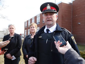 Emily Mountney-Lessard/The Intelligencer
Belleville Police Service Inspector Michael Callaghan addresses members of the media outside Quinte Secondary School on Friday in Belleville. Shown in back are QSS principal Liane Woodley and Hastings and Prince Edward District School Board director of education Mandy Savery-Whiteway.