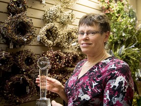 Marilyn Trautman, who won the Womanition magazine Entrepreneur of the Year award for 2016, poses with the award in her store, located south of Spruce Grove, on Thursday, March 3, 2016. - Photo by Yasmin Mayne