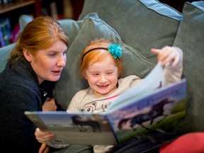 submitted photo
Marlow Ploughman reads a book at Ronald McDonald House in Toronto while her mother, Tanya, looks on. Ploughman has been fighting cancer for more than two years and has had to spend a great deal of time living at RMHC with her parents.