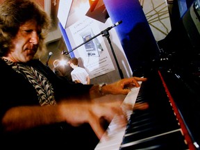 In this Aug. 12, 1999 file photo, musician Keith Emerson plays the new Van Koevering Interactive Piano, designed by electronic engineer Bob Moog, in Beverly Hills, Calif. Emerson, the keyboardist and founding member of the 1970s progressive rock group Emerson, Lake and Palmer, died Thursday, March 10, 2016, at home in Santa Monica, Calif. He was 71.  (AP Photos/Damian Dovarganes, File)