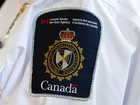 A Canada Border Services Agency (CBSA) logo is seen on a worker during a tour of the Infield Terminal at Toronto Pearson International Airport in this December 8, 2015 filephoto. (REUTERS/Mark Blinch)