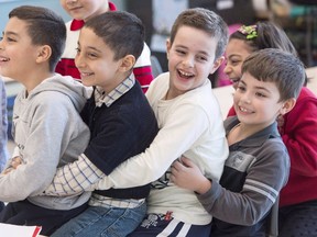 Syrian refugees Jamil Haddad, left, and Tony Batekh, 2nd left, George Louka and Edmon Artin, right, have some fun while they attend French classes at a school Wednesday, February 17, 2016 in Montreal. There are now just over 25,000 Syrian refugees who've arrived in Canada since the Liberal government rolled out its $678-million plan for refugee resettlement in November that targeted having that many people here by the end of this month. THE CANADIAN PRESS/Ryan Remiorz