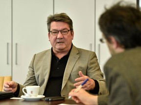 Juergen Fischenich, left,  speaks  during an interview with  The Associated Press  in Moenchengladbach, Germany, Friday, March 11, 2016. His 33-year-old son Sven Fischenich died in the Germanwings plane crash last year, in the French Alps on its way from Barcelona to Duesseldorf killing all 150 people on board.  At right Associated Press correspondent Frank Jordans. (AP Photo/Martin Meissner)