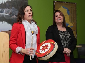Vanessa McCourt and Laura Maracle of Four Directions aboriginal Student Centre at Queen's University play a traditional drum song after Kingston and the Islands MPP Sophie Kiwala announced funding for aboriginal education programs for St. Lawrence College and Queen's University at the Eagle Learning Centre at St. Lawrence College in Kingston on Friday. (Ian MacAlpine/The Whig-Standard)