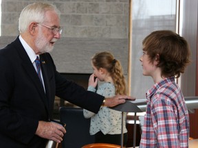 Arthur McDonald speaks to a student after delivering a keynote address at Inquiry@Queen's research conference on Friday. (Steph Crosier/The Whig-Standard)