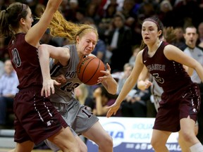 Ottawa Gee-Gees’ Catherine Traer drives past Rachael Holmes (left) of the McMaster Marauders on March 12. (Julie Oliver, Postmedia Network)