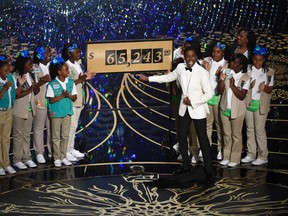 Host Chris Rock and Girl Scouts participate in a skit at the Oscars on Sunday, Feb. 28, 2016, at the Dolby Theatre in Los Angeles. (Photo by Chris Pizzello/Invision/AP)