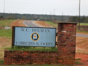 The sign to The William C. Holman Correctional Facility in Atmore, Ala., is displayed on Saturday March 12, 2016. Department of Corrections spokesman Bob Horton said three emergency response teams were deployed to bring the prison dorm under control. (Sharon Steinmann/AL.com via AP)