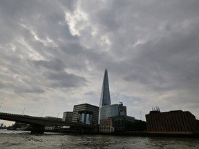 A Thursday, June 19, 2014 photo from files of the Shard as seen from the river Thames in London. Witnesses say a base jumper has safely parachuted from the European Union’s tallest building, the Shard in London, and evaded police by jumping on the subway. (AP Photo/Lefteris Pitarakis)