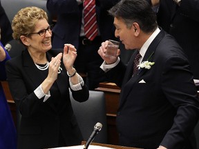 Ontario Minister of Finance Charles Sousa presents the Ontario 2016 Budget with Premier Kathleen Wynne looking on. (Craig Robertson/Toronto Sun/Postmedia Network)