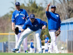 Toronto Blue Jays' Justin Smoak, front, Chris Colabello, left, and Edwin Encarnacion participate in a ground-ball drill at the team's spring training facility in Dunedin on Feb. 27, 2016. (THE CANADIAN PRESS/Frank Gunn)