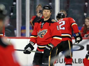 Dennis Wideman is all smiles after being reinstated during warm-up before playing the Arizona Coyotes at the Scotiabank Saddledome in Calgary on March 11, 2016. (Leah Hennel/Postmedia)