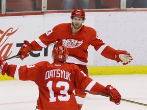 Detroit Red Wings center Darren Helm is congratulated by Detroit Red Wings center Pavel Datsyuk after scoring during an overtime period of an NHL hockey game against the New York Rangers, Saturday, March 12, 2016, in Detroit.  (AP Photo/Carlos Osorio)