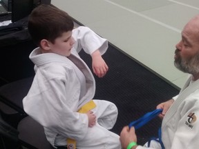 Nolan Morris talks to his sensei, Bruce Sydnam, during the Edmonton International Judo Champioships at West Edmonton Mall on Saturday. Blind since birth, Morris won gold at the event. (Jason Hills)