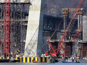 Boats of emergency officials work near the site of a fatal collision in the water underneath the Tappan Zee Bridge in Tarrytown, N.Y., Saturday, March 12, 2016. New York State Police say one person is dead after a tugboat sank on the Hudson River north of New York City early Saturday morning. (AP Photo/Seth Wenig)