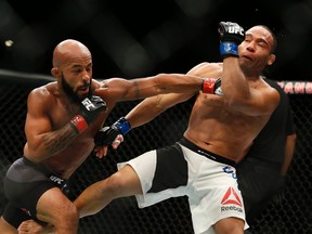 Demetrious Johnson hits John Dodson during their flyweight title mixed martial arts bout at UFC 191, Saturday, Sept. 5, 2015, in Las Vegas. (AP Photo/John Locher)