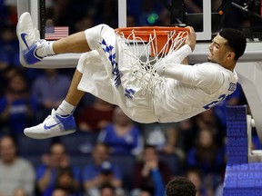Kentucky guard Jamal Murray hangs on the rim after dunking the ball against Georgia during the SEC basketball tournament at Bridgestone Arena. (George Walker IV/The Tennessean via USA TODAY NETWORK)