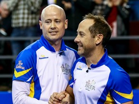 Team Alberta skip Kevin Koe congratulates second Brent Laing after they defeated Team Northern Ontario during play at the 2016 Brier in Ottawa on Saturday March 12, 2016. (Errol McGihon, Postmedia Network)