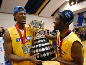 Ryerson Rams' Juwon Grannum (22) and Andy Agyepong (right) hold the Wilson Cup after capturing the OUA basketball final Saturday night with a 73-68 win over Carleton at the Mattamy Athletic Centre. (JACK BOLAND, Toronto Sun)