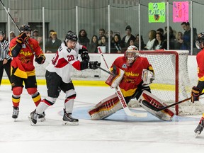 Carleton Ravens forward Brett Welychka tries to bat a puck past Guelph Gryphons goalie Andrew D’Agostini in the OUA third-place game. (Marc Lafleur/photo)