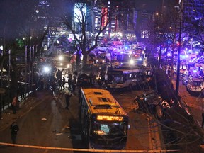 Members of emergency services work at the scene of an explosion in Ankara, Turkey, Sunday, March 13, 2016. A television channel said the bomb exploded close to bus stops near a park at Ankara's main square, Kizilay. The news channel said the explosion occurred as a car slammed into a bus, suggesting that the blast may have been caused by a car bomb. Several vehicles had caught fire, it said. (AP Photo)