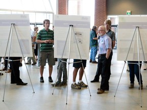 Members of the public look at posters showing the impact of a proposed rapid transit system on areas including downtown, the Old East Village, and Western University, at a public information session about Shift, a transportation initiative focused on the future of transit in London, at the Western Fair District Agriplex in London, Ont. on Thursday May 28, 2015. The drop-in session gives the public a look at the preliminary plans and give feedback. (CRAIG GLOVER, The London Free Press)