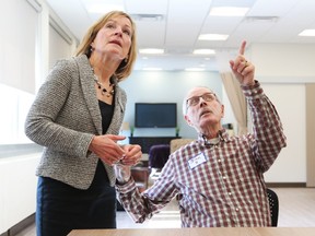 Algonquin College president Cheryl Jensen chats with patient John at the new Algonquin College health-care room. Jean Levac