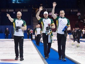 Team Northern Ontario skip Brad Jacobs, left, second E.J. Harnden, right, and Ryan Harnden wave to the audience following the bronze medal game against Team Manitoba at the Brier curling championship, Sunday, March 13, 2016 in Ottawa. Northern Ontario defeated Manitoba 7-6 in an extra end to win the bronze medal. (THE CANADIAN PRESS/Adrian Wyld)