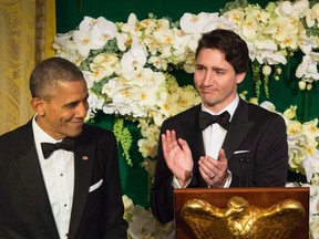 Prime Minister Justin Trudeau applauds US President Barack Obama during a state dinner Thursday, March 10, 2016 in Washington.