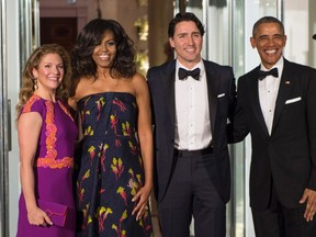 President Barack Obama and first lady Michelle Obama pose for a photo with Canadian Prime Minister Justin Trudeau and Sophie Grégoire Trudeau at the North Portico of the White House in Washington, Thursday, March 10, 2016, as they arrive for a state dinner. THE CANADIAN PRESS/Paul Chiasson