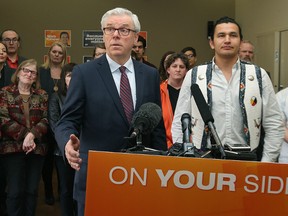 Premier Greg Selinger speaks during a Friday press conference at a podium bearing the slogan "on your side." It appears a growing number of Winnipeggers agree with the sentiment. (Kevin King/Winnipeg Sun/Postmedia Network)