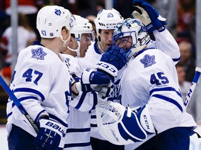 Leo Komarov (left) and teammates congratulate goalie Jonathan Bernier after the Maple Leafs beat the Red Wings 1-0 in Detroit on Sunday night. (USA TODAY Sports)