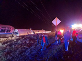 Passengers gather after a train derailed near Dodge City, Kan., Monday, March 14, 2016. An Amtrak statement says the train was traveling from Los Angeles to Chicago early Monday when it derailed just after midnight. (Daniel Szczerba via AP)