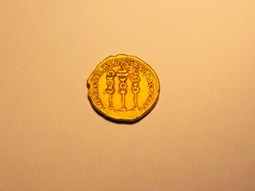 A rare, nearly 2,000-year-old gold coin, at the Antiquities Authority office inside the Israel Museum in Jerusalem, Monday, March 14, 2016. Israel's Antiquities Authority says a hiker has found a rare, nearly 2,000-year-old gold coin. The authority said Monday that the ancient coin appears to be only the second of its kind to have been found. It said London's British Museum possesses the other coin. (AP Photo/Ariel Schalit)