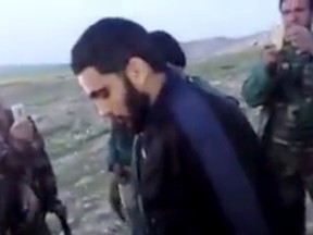 This image made from video posted on Twitter by a Kurdish fighter shows a man that the Kurdish military says is an American member of the Islamic State group shortly after he turned himself in to Kurdish fighters in northern Iraq, Monday, March 14, 2016. The circumstances of the surrender were not fully disclosed but it marked a rare instance in which an IS fighter voluntarily gave himself up to Iraqi or Kurdish forces in Iraq. (Kurdish fighter via AP)