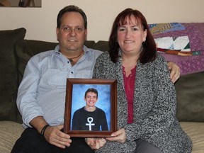 Gary Labelle and Karen McIntosh with a picture of McIntosh's son Matthew on Saturday March 12, 2016 in Cornwall, Ont. The Cornwall couple started a petition to get cameras in the common areas of group homes to protect staff and clients. Lois Ann Baker/Cornwall Standard-Freeholder/Postmedia Network