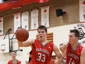 Donovan Yaceyko and Brayden Drury hustle for a rebound during the Marauders’ gold medal game against Assumption High School. The Marauders lost 55-52 in a back-and-forth affair.