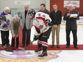 The opening ceremonies of the 67th Young Canada Week hockey tournament took place at the Maitland Recreation Centre on March 11. On hand for the puck-drop was, back row from left to right, Bob Robson, Larry Jeffrey, Audrey McCabe, Bruce Erskine, Kevin Morrison, Devin Scully and Richard Madge. Captain of the Sailors Peewee Lions rep team, Evan B., took the faceoff against the Kawartha Coyotes’ captain. (Laura Broadley/Goderich Signal Star)