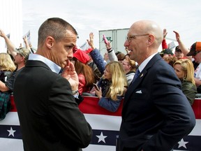 U.S. Republican presidential candidate Donald Trump's campaign manager Corey Lewandowski speaks with an unidentified aide after a demonstrator was detained at a rally at the Dayton International Airport in Dayton, Ohio March 12, 2016. (REUTERS/William Philpott)