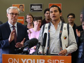 Premier Greg Selinger applauds while Wab Kinew, NDP candidate for Fort Rouge, speaks during a press conference last Friday. (Kevin King/Winnipeg Sun file photo)