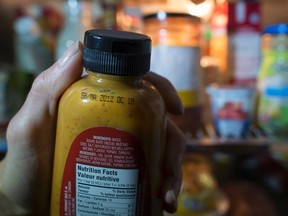A bottle of prepared mustard condiment past its expiry date is shown in Toronto on Sunday, March 13, 2016. THE CANADIAN PRESS/Graeme Roy