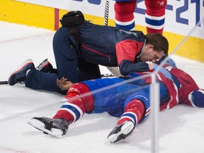 Montreal Canadiens defenceman P.K. Subban is tended to by medical staff during a game against the Buffalo Sabres in Montreal, Thursday, March 10, 2016. (THE CANADIAN PRESS/Graham Hughes)