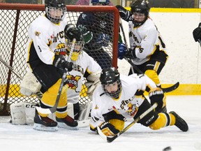 Wade Monden (left), goalie Greg Reidy, Evan MacArthur and Curtis Chaffe of the Mitchell Pee Wee AE’s keep their eyes on the puck in front of the Mitchell net during Game 4 of their OMHA AE Group 4/5 series last Saturday with visiting Durham. The visitors won 3-2 and then claimed the series with a 4-0 win in Mitchell Sunday. GALEN SIMMONS/MITCHELL ADVOCATE