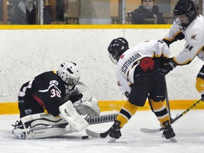 Jackson MacArthur and Zach Dow of the Mitchell Bantams pressure the Hanover goalie during earlier OMHA playoff action. The Meteors lead Bancroft 2-0 and head home for Games 3, 4 and 5 with a chance to win the OMHA 'CC' crown. ANDY BADER/MITCHELL ADVOCATE