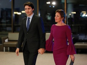 Prime Minister Justin Trudeau, left, and his wife Sophie Gregoire-Trudeau make their way to a dinner hosted for United Nations Secretary General Ban Ki-moon in Gatineau, Que., on Thursday, February 11, 2016. THE CANADIAN PRESS/Fred Chartrand