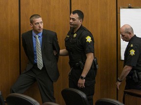 Ex-Trooper Sean Groubert, left, looks back at his wife as he is taken into custody after he pleaded guilty Monday, March 14, 2016, to the charge of assault and battery of high and aggravated nature for the 2014 shooting ofLevar Jones during a traffic stop. (Tim Dominick/The State via AP)